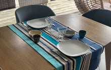 chemin de table élégant sur fond bleu pour un rappel du bord de mer et un repas élégant. En mettre deux pour diner à quatre. 